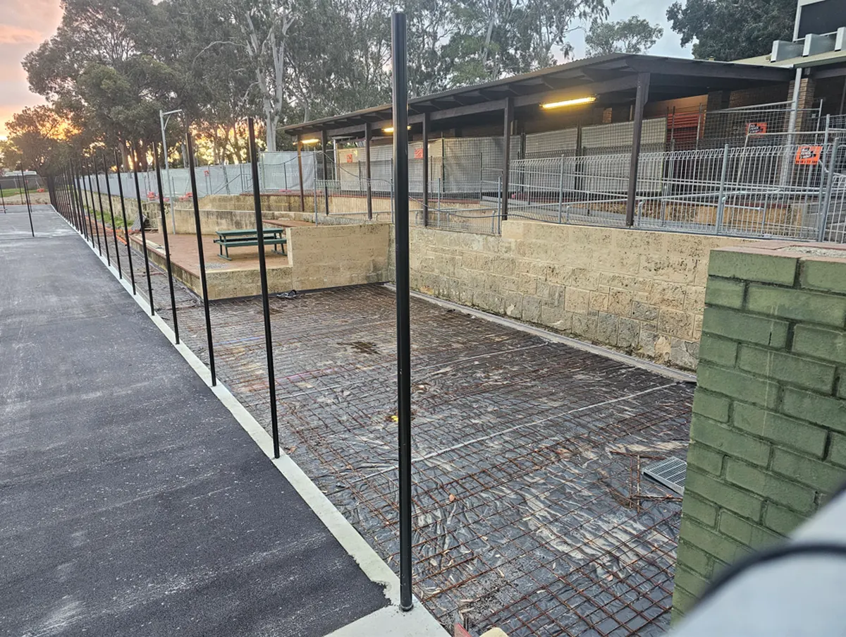 Pathways and fencing beside the Wanneroo Tennis Club clubroom during the court renewal
